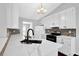 Well-lit kitchen with stainless steel appliances, white cabinetry, quartz countertops, and tiled backsplash at 2865 Maple Vista Ln, Lawrenceville, GA 30044