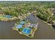 Aerial view of a lakeside tennis club with multiple courts, pool, and lush surrounding greenery at 6960 Dockbridge Way, Stone Mountain, GA 30087