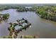Aerial view of lakefront tennis club featuring a pool, multiple tennis courts and scenic surrounding nature at 6960 Dockbridge Way, Stone Mountain, GA 30087