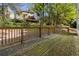 Wooden deck with railing overlooking a yard with trees, perfect for outdoor living at 6960 Dockbridge Way, Stone Mountain, GA 30087