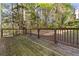 Rustic wooden deck overlooking a leafy backyard, perfect for outdoor relaxation at 6960 Dockbridge Way, Stone Mountain, GA 30087