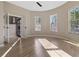 Sunlit bedroom with a barrel ceiling, hardwood floors, and access to another room with French doors at 6960 Dockbridge Way, Stone Mountain, GA 30087