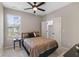 Cozy bedroom featuring neutral colors, a ceiling fan, and a window with natural light at 6960 Dockbridge Way, Stone Mountain, GA 30087