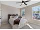 Cozy bedroom with neutral decor, plush carpet, and two large windows offering pleasant natural light at 6960 Dockbridge Way, Stone Mountain, GA 30087