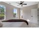 Bright bedroom featuring carpeted floors, neutral walls, and natural light from large windows at 6960 Dockbridge Way, Stone Mountain, GA 30087
