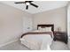 Cozy bedroom with neutral walls, a ceiling fan, and a comfortable bed with stylish brown and white bedding at 6960 Dockbridge Way, Stone Mountain, GA 30087
