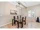 Bright dining room features modern lighting and an elegant glass table at 6960 Dockbridge Way, Stone Mountain, GA 30087