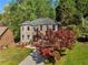 Beautiful two-story brick home with mature landscaping and a winding driveway at 6960 Dockbridge Way, Stone Mountain, GA 30087