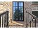 Charming front entrance featuring a double door, brick facade, stone accents, and black metal railings at 6960 Dockbridge Way, Stone Mountain, GA 30087