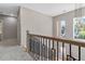 The stairway landing offers natural light and an open view of the first floor at 6960 Dockbridge Way, Stone Mountain, GA 30087