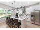 Kitchen features a center island with seating, stainless steel appliances and lots of natural light at 6960 Dockbridge Way, Stone Mountain, GA 30087