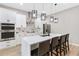 Modern kitchen featuring white cabinetry, quartz countertops, and stainless steel appliances at 6960 Dockbridge Way, Stone Mountain, GA 30087