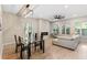 Open concept living room and dining area with modern decor, fireplace, and large windows at 6960 Dockbridge Way, Stone Mountain, GA 30087