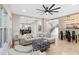 Open-concept living room with modern furnishings, hardwood floors, and seamless flow to the dining and kitchen areas at 6960 Dockbridge Way, Stone Mountain, GA 30087