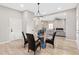 Cozy living room view featuring a dining area, neutral walls, and hardwood floors at 6960 Dockbridge Way, Stone Mountain, GA 30087