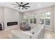 Comfortable living room showcases sleek ceiling fan, modern fireplace, and abundant natural light at 6960 Dockbridge Way, Stone Mountain, GA 30087