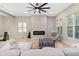 Bright living room features a fireplace, modern ceiling fan, and ample windows at 6960 Dockbridge Way, Stone Mountain, GA 30087