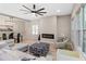 Open living space features modern décor, fireplace, and a contemporary ceiling fan at 6960 Dockbridge Way, Stone Mountain, GA 30087