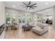 Spacious living room displays a modern ceiling fan and plentiful natural light at 6960 Dockbridge Way, Stone Mountain, GA 30087