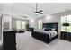 Spacious primary bedroom with a trey ceiling, plush carpeting, and large windows providing ample natural light at 6960 Dockbridge Way, Stone Mountain, GA 30087