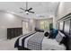 This primary bedroom has a ceiling fan, tray ceiling, black-out curtains, and a large window at 6960 Dockbridge Way, Stone Mountain, GA 30087