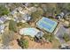 Aerial view showcasing the community's amenities, including a pool and tennis courts at 11570 Dunhill Place Dr, Johns Creek, GA 30005