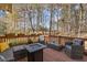 Stylish outdoor deck with seating, string lights, and backyard view, ideal for enjoying the outdoors at 11570 Dunhill Place Dr, Johns Creek, GA 30005