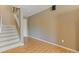 Spacious basement area featuring hardwood floors and a staircase leading to other levels at 11570 Dunhill Place Dr, Johns Creek, GA 30005