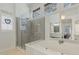 Stylish bathroom offers a glass-enclosed shower, a soaking tub, and double windows at 11570 Dunhill Place Dr, Johns Creek, GA 30005