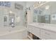 Luxury bathroom features a soaking tub, double vanity, large mirrors, and a glass shower at 11570 Dunhill Place Dr, Johns Creek, GA 30005