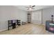 Empty room features ceiling fan, light hardwood floors, and lots of natural light at 11570 Dunhill Place Dr, Johns Creek, GA 30005