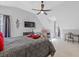 Bright bedroom boasts a ceiling fan and stylish wall decorations at 11570 Dunhill Place Dr, Johns Creek, GA 30005