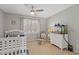 Cozy bedroom offers neutral tones with a ceiling fan and lots of natural light at 11570 Dunhill Place Dr, Johns Creek, GA 30005