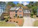 Charming two-story brick home with a well-manicured lawn and an attached two-car garage at 11570 Dunhill Place Dr, Johns Creek, GA 30005