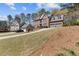 View of homes with well-maintained lawns, landscaping, and attached garages at 11570 Dunhill Place Dr, Johns Creek, GA 30005