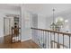 Second floor foyer with hardwood floors, decorative wrought iron, and natural light at 11570 Dunhill Place Dr, Johns Creek, GA 30005