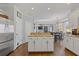 The kitchen area boasts an island, stainless steel refrigerator, and hardwood floors at 11570 Dunhill Place Dr, Johns Creek, GA 30005