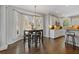 Bright eat-in kitchen boasts hardwood floors, white cabinetry, and a bay window at 11570 Dunhill Place Dr, Johns Creek, GA 30005
