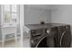 Well-equipped laundry room with modern washer and dryer units and a convenient utility sink at 11570 Dunhill Place Dr, Johns Creek, GA 30005
