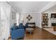 Bright and airy living room with large windows and a cozy seating area at 11570 Dunhill Place Dr, Johns Creek, GA 30005