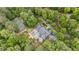 Stunning aerial view of estate with pool, tennis court and lush, mature landscaping offering a private and serene setting at 440 Old Homestead Trl, Johns Creek, GA 30097
