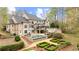 Expansive backyard featuring a pristine pool, outdoor patio, and beautifully manicured greenery at 440 Old Homestead Trl, Johns Creek, GA 30097