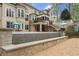 Beautiful backyard with multiple patios, lush landscaping, and a water feature at 440 Old Homestead Trl, Johns Creek, GA 30097