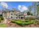 Expansive backyard featuring patio, lush landscaping, and a flowing water feature at 440 Old Homestead Trl, Johns Creek, GA 30097