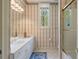 Classic bathroom with a shower, decorative wallpaper, and single-sink vanity at 440 Old Homestead Trl, Johns Creek, GA 30097