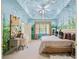 Cozy bedroom featuring whimsical muraled walls, a plush king bed, and soft neutral carpet at 440 Old Homestead Trl, Johns Creek, GA 30097