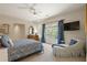 Relaxing bedroom featuring a ceiling fan, tv, blue accents and a chaise lounge at 440 Old Homestead Trl, Johns Creek, GA 30097