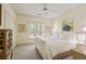 Comfortable bedroom features a ceiling fan, closet, and a large window for natural light at 440 Old Homestead Trl, Johns Creek, GA 30097