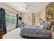 Serene bedroom with a ceiling fan, blue accents, and a cozy reading nook by the window at 440 Old Homestead Trl, Johns Creek, GA 30097