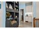 Butler's pantry featuring gray built-in shelving, white cabinets, wet bar, and blue walls at 440 Old Homestead Trl, Johns Creek, GA 30097